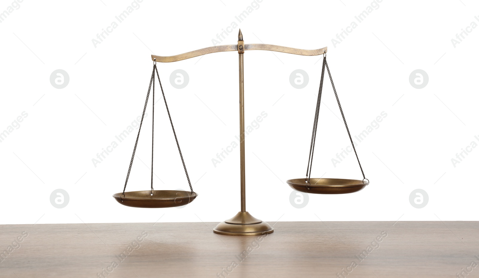 Photo of Golden scales of justice on wooden table against white background