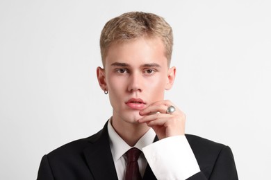 Photo of Handsome young man wearing stylish suit on white background