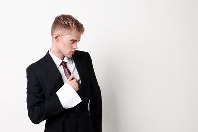 Photo of Handsome young man wearing stylish suit on white background