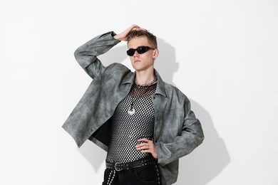 Photo of Handsome young man wearing stylish jacket and sunglasses on white background