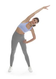 Photo of Teenage girl in sportswear stretching on white background