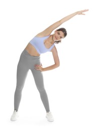 Photo of Teenage girl in sportswear stretching on white background