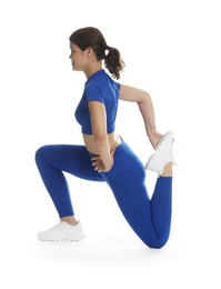 Photo of Teenage girl in sportswear stretching on white background