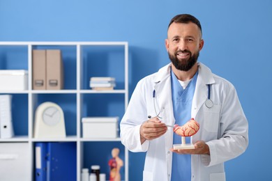 Photo of Gastroenterologist with model of stomach in clinic