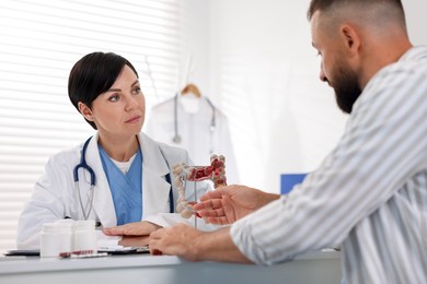 Photo of Man having appointment with gastroenterologist in clinic