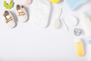Photo of Baby accessories and cosmetic products on white background, flat lay. Space for text