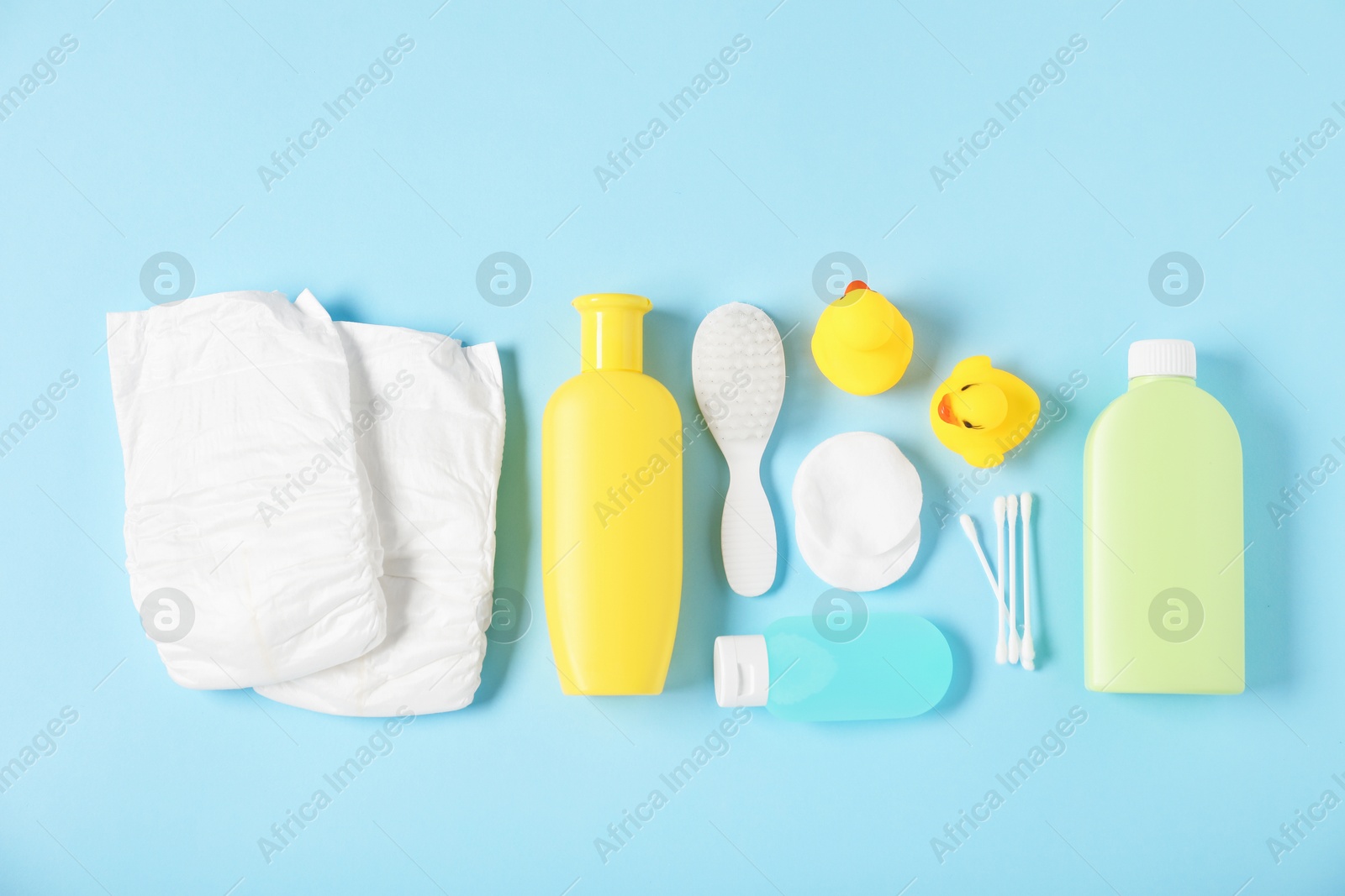 Baby accessories and cosmetic products on light blue background, flat lay Photo of Baby accessories and cosmetic products on light blue background, flat lay