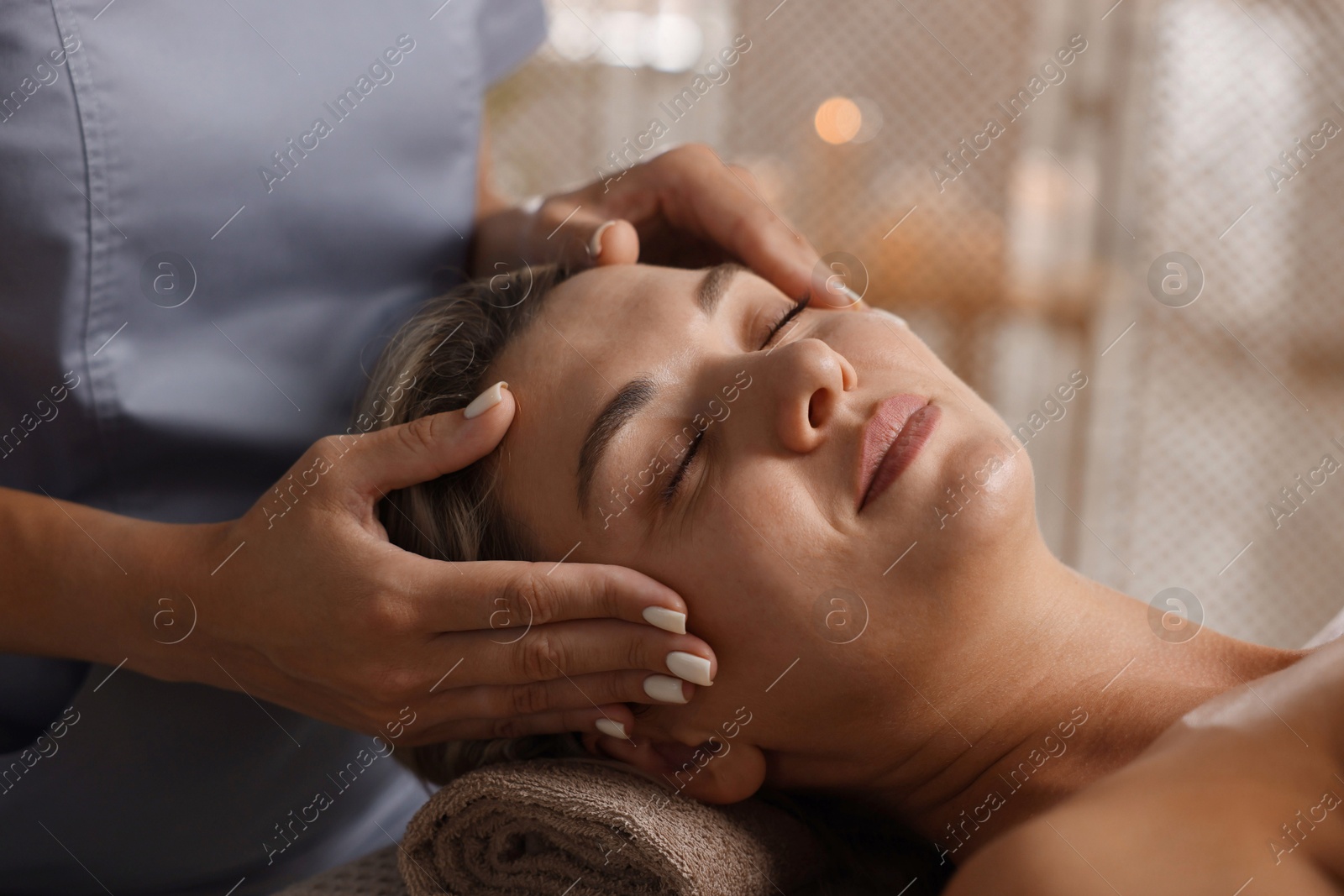 Beautiful woman receiving facial massage in spa salon, closeup Photo of Beautiful woman receiving facial massage in spa salon, closeup