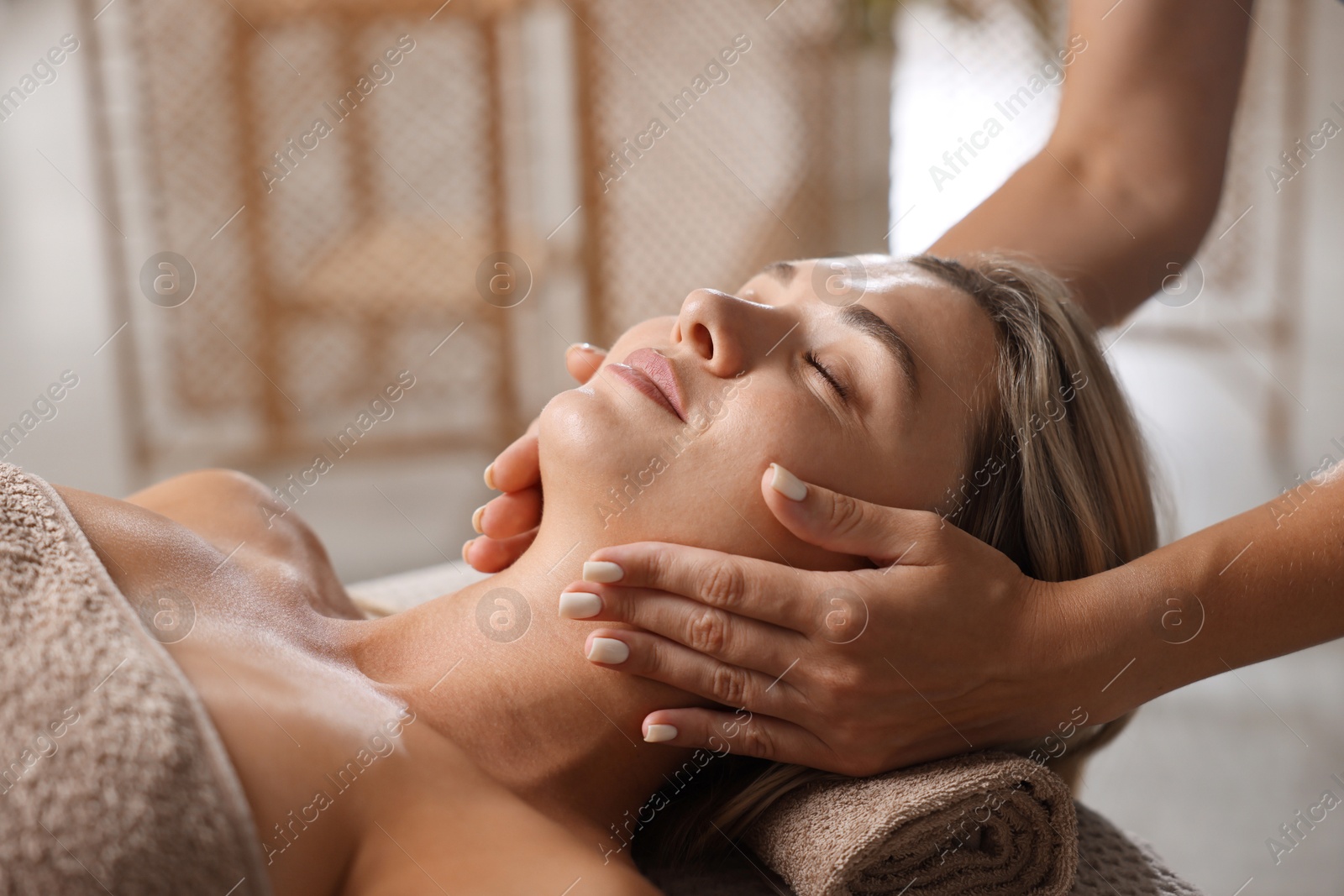 Beautiful woman receiving facial massage in spa salon, closeup Photo of Beautiful woman receiving facial massage in spa salon, closeup