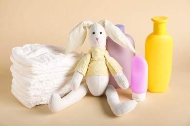 Photo of Baby accessories and cosmetic products on beige background