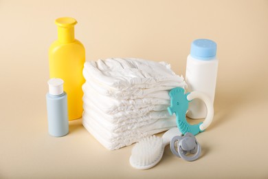 Photo of Baby accessories and cosmetic products on beige background