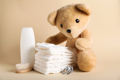 Photo of Baby accessories and cosmetic product on beige background