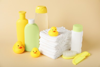 Photo of Baby accessories and cosmetic products on beige background