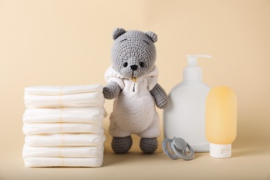 Photo of Baby accessories and cosmetic products on beige background