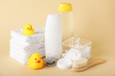 Photo of Baby accessories and cosmetic products on beige background
