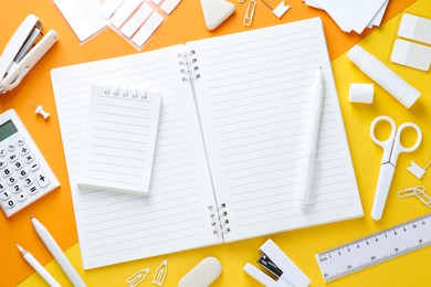 Photo of White stationery on color background, flat lay