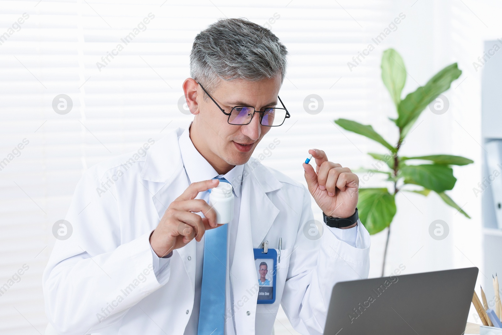 Telemedicine. Doctor having video call with patient via laptop indoors Photo of Telemedicine. Doctor having video call with patient via laptop indoors