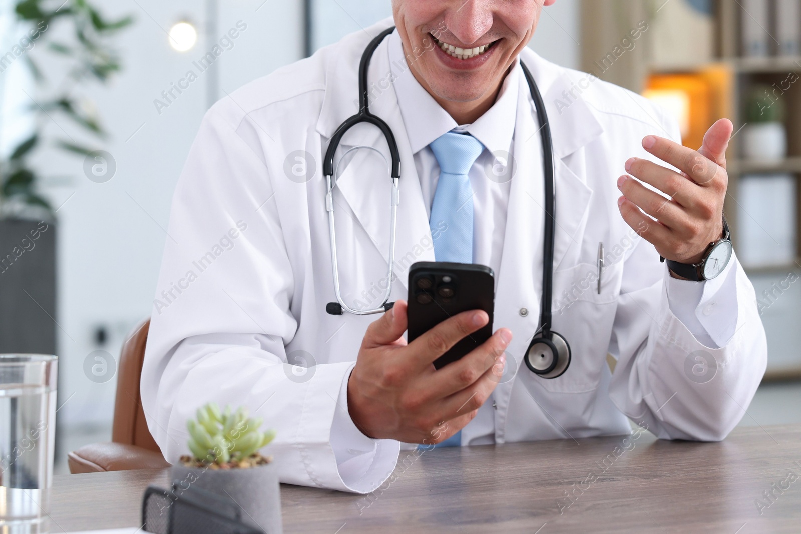 Telemedicine. Doctor having video call with patient via smartphone indoors, closeup Photo of Telemedicine. Doctor having video call with patient via smartphone indoors, closeup