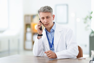 Photo of Telemedicine. Doctor having call with patient indoors