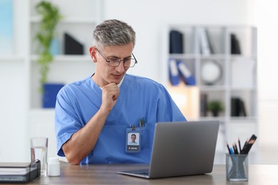 Photo of Telemedicine. Doctor having video call with patient via laptop indoors