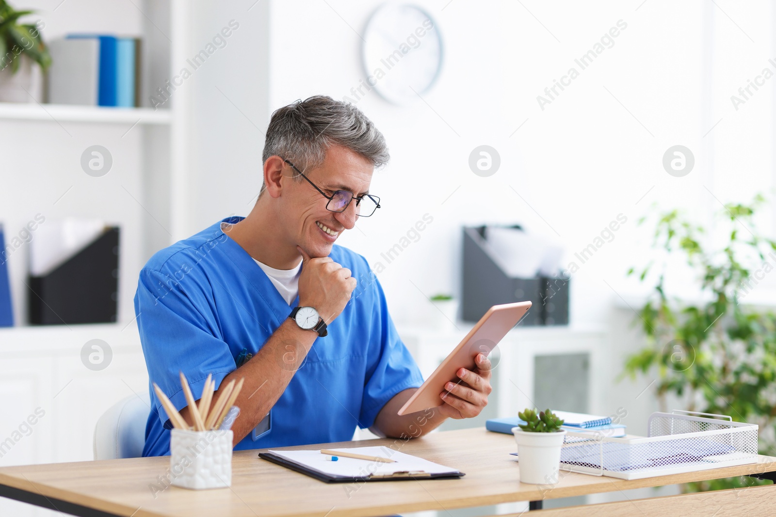 Telemedicine. Doctor having video call with patient via tablet indoors Photo of Telemedicine. Doctor having video call with patient via tablet indoors