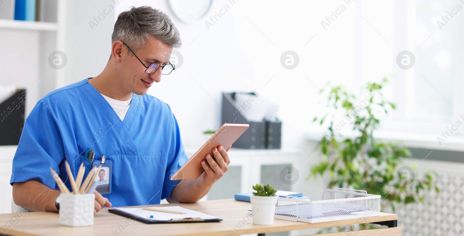 Telemedicine. Doctor having video call with patient via tablet indoors Photo of Telemedicine. Doctor having video call with patient via tablet indoors
