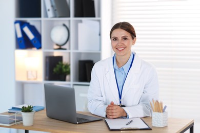 Photo of Telemedicine. Doctor having video call with patient via laptop indoors