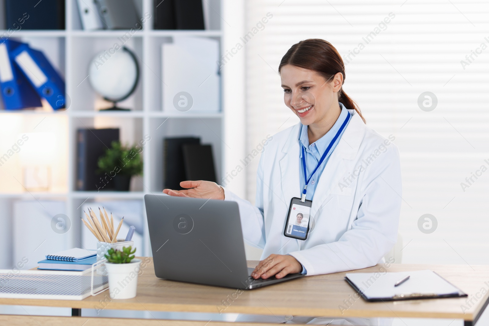 Telemedicine. Doctor having video call with patient via laptop indoors Photo of Telemedicine. Doctor having video call with patient via laptop indoors