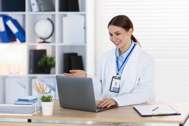 Photo of Telemedicine. Doctor having video call with patient via laptop indoors