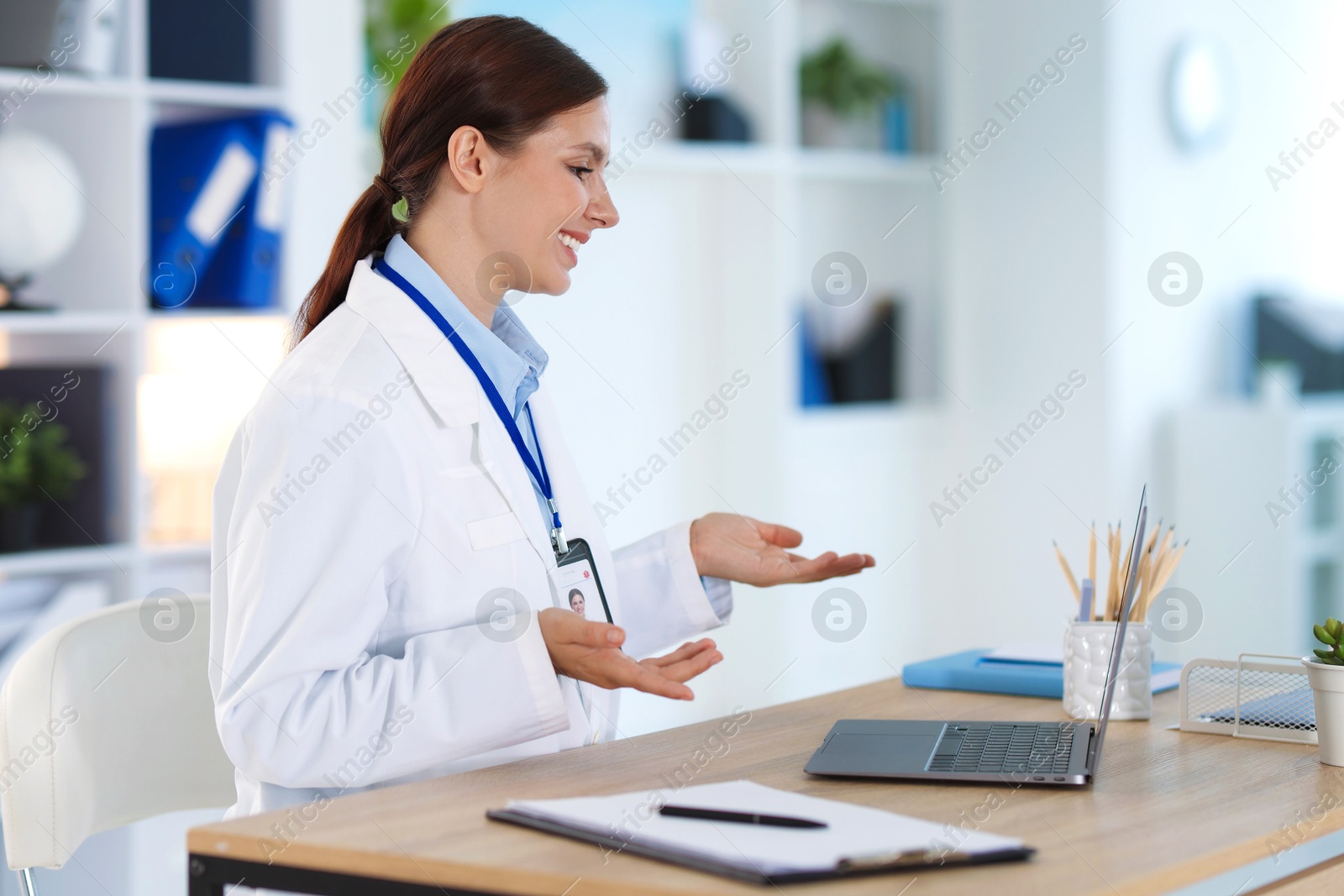 Telemedicine. Doctor having video call with patient via laptop indoors Photo of Telemedicine. Doctor having video call with patient via laptop indoors