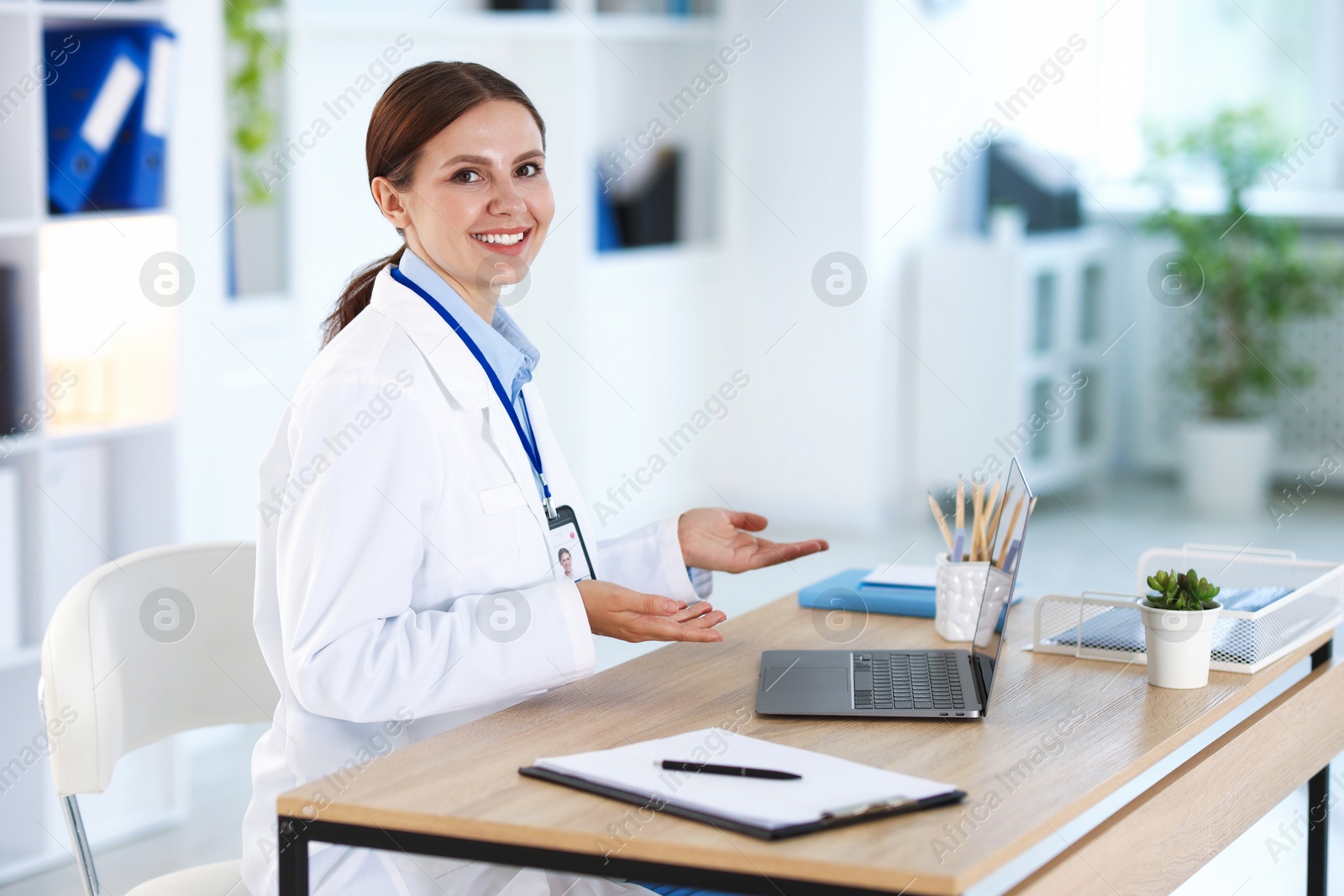Telemedicine. Doctor having video call with patient via laptop indoors Photo of Telemedicine. Doctor having video call with patient via laptop indoors