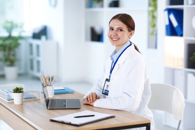 Photo of Telemedicine. Doctor having video call with patient via laptop indoors
