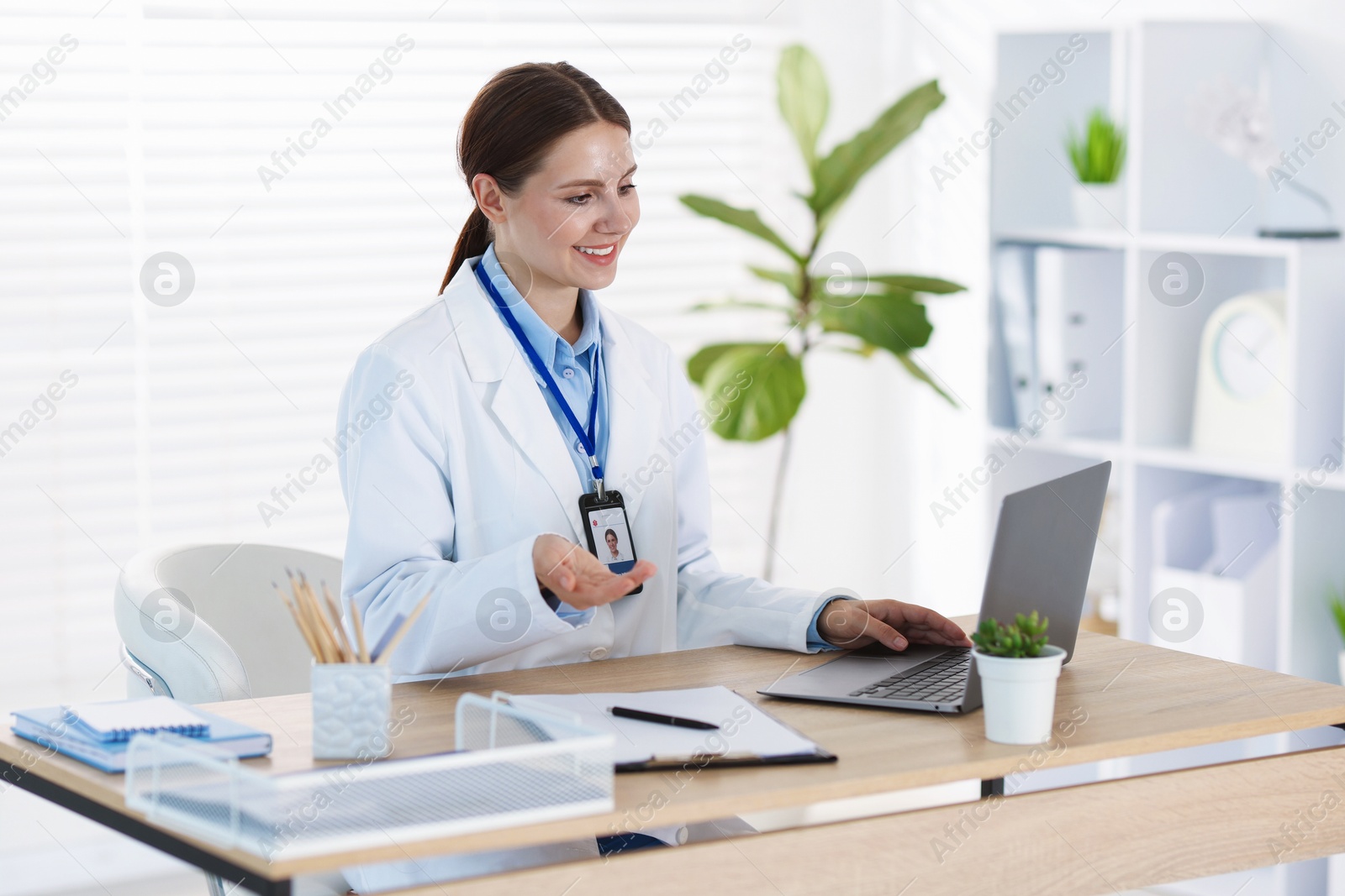 Telemedicine. Doctor having video call with patient via laptop indoors Photo of Telemedicine. Doctor having video call with patient via laptop indoors