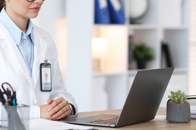 Photo of Telemedicine. Doctor having video call with patient via laptop indoors, closeup