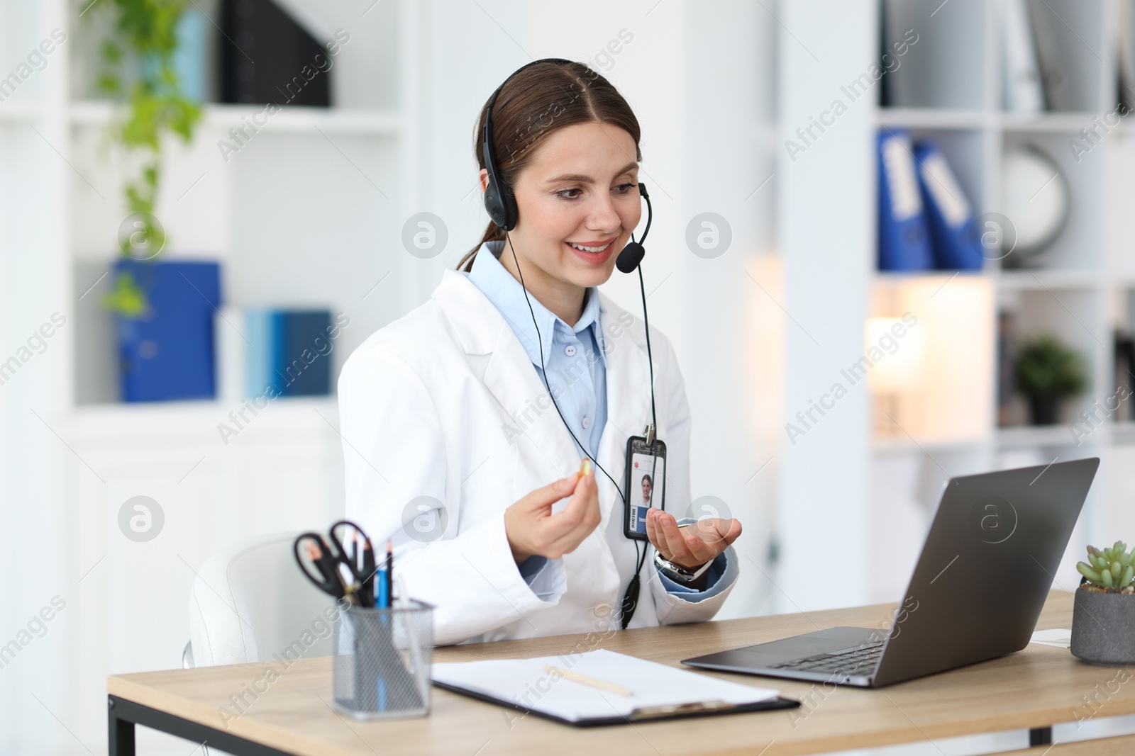 Telemedicine. Doctor having video call with patient via laptop indoors Photo of Telemedicine. Doctor having video call with patient via laptop indoors