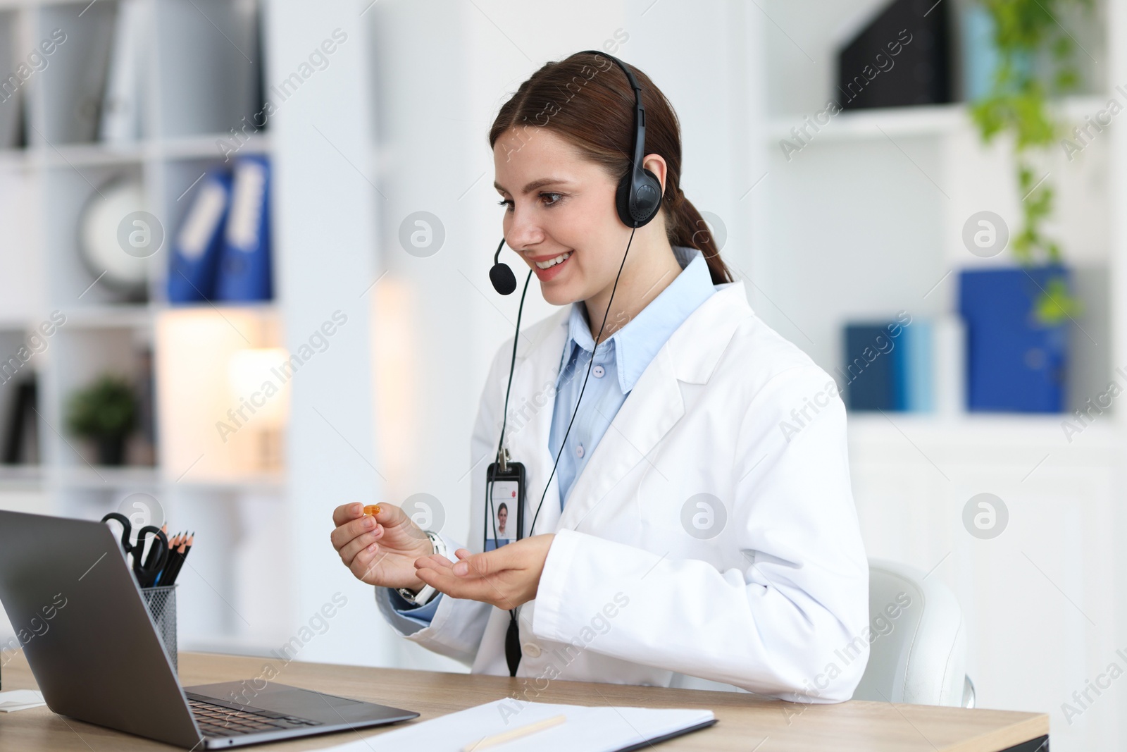 Telemedicine. Doctor having video call with patient via laptop indoors Photo of Telemedicine. Doctor having video call with patient via laptop indoors