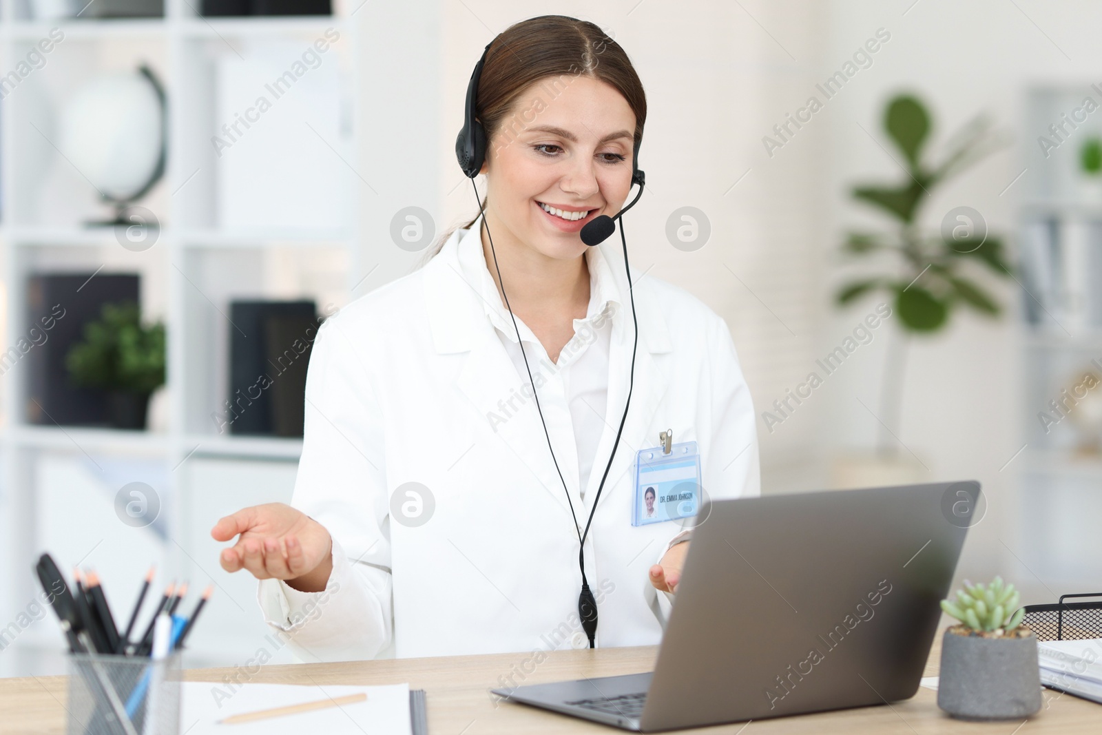 Telemedicine. Doctor having video call with patient via laptop indoors Photo of Telemedicine. Doctor having video call with patient via laptop indoors