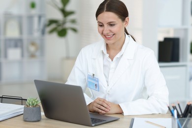 Photo of Telemedicine. Doctor having video call with patient via laptop indoors