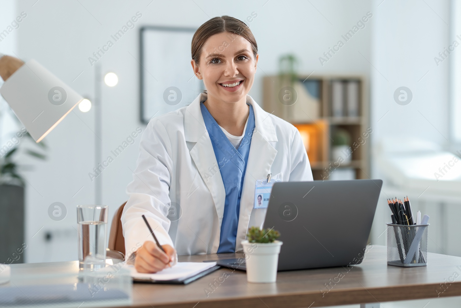 Telemedicine. Doctor making notes while having video call with patient via laptop indoors Photo of Telemedicine. Doctor making notes while having video call with patient via laptop indoors