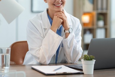Photo of Telemedicine. Doctor having video call with patient via laptop indoors, closeup