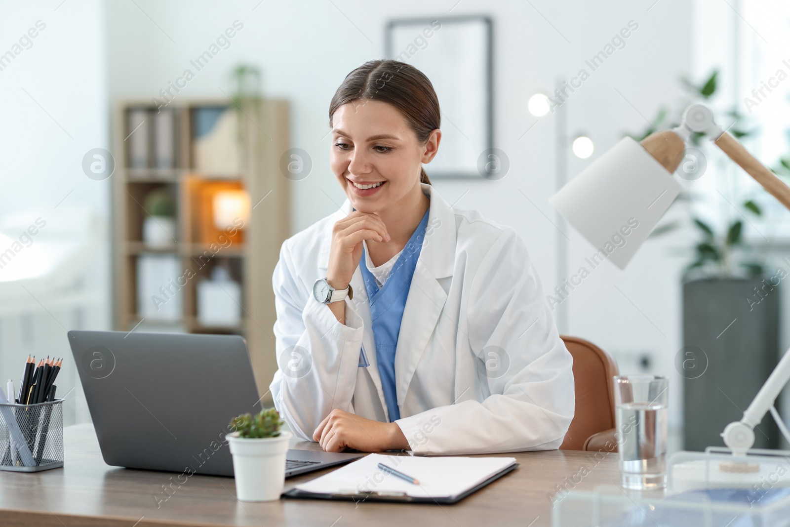 Telemedicine. Doctor having video call with patient via laptop indoors Photo of Telemedicine. Doctor having video call with patient via laptop indoors