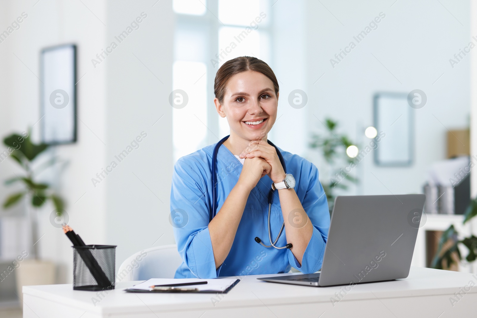 Telemedicine. Doctor having video call with patient via laptop indoors Photo of Telemedicine. Doctor having video call with patient via laptop indoors