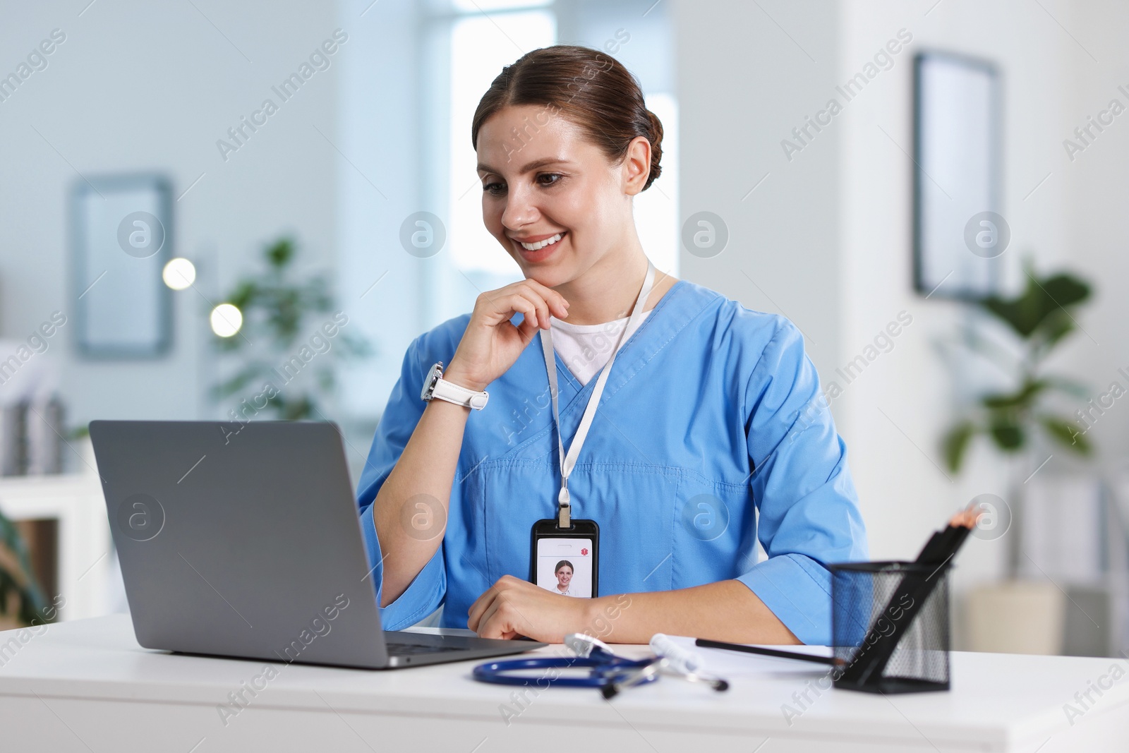 Telemedicine. Doctor having video call with patient via laptop indoors Photo of Telemedicine. Doctor having video call with patient via laptop indoors