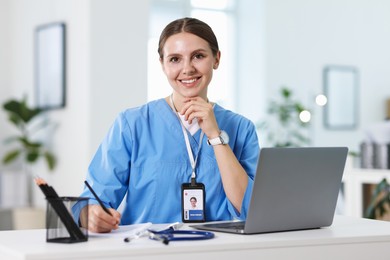 Photo of Telemedicine. Doctor having video call with patient via laptop indoors