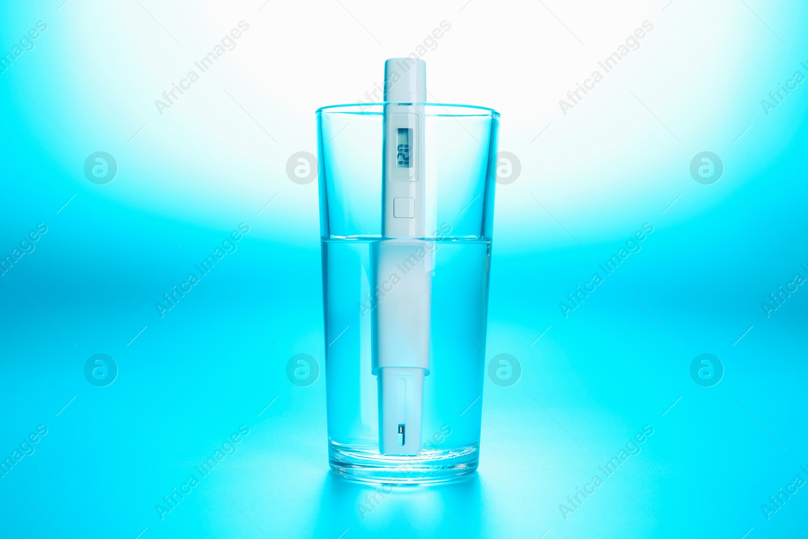 Nitrate tester in glass of water on light blue background Photo of Nitrate tester in glass of water on light blue background