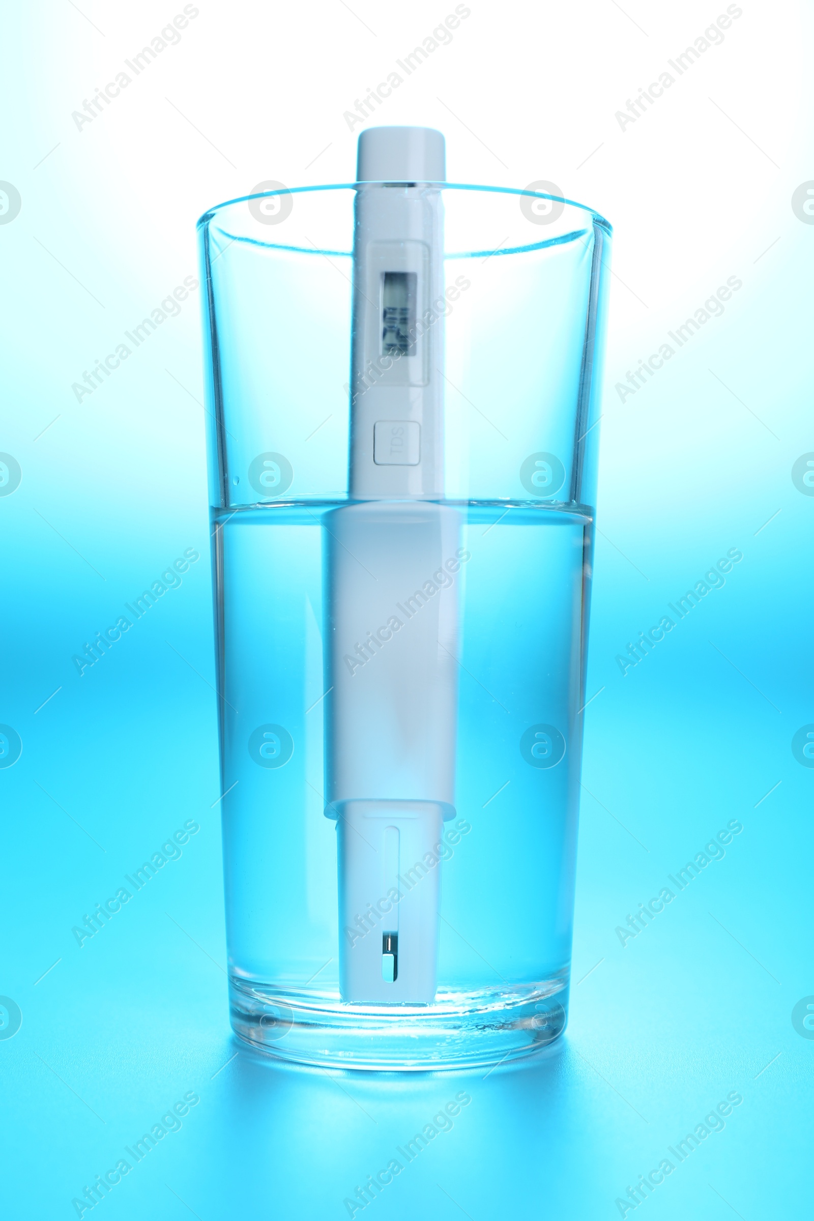 Nitrate tester in glass of water on light blue background, closeup Photo of Nitrate tester in glass of water on light blue background, closeup