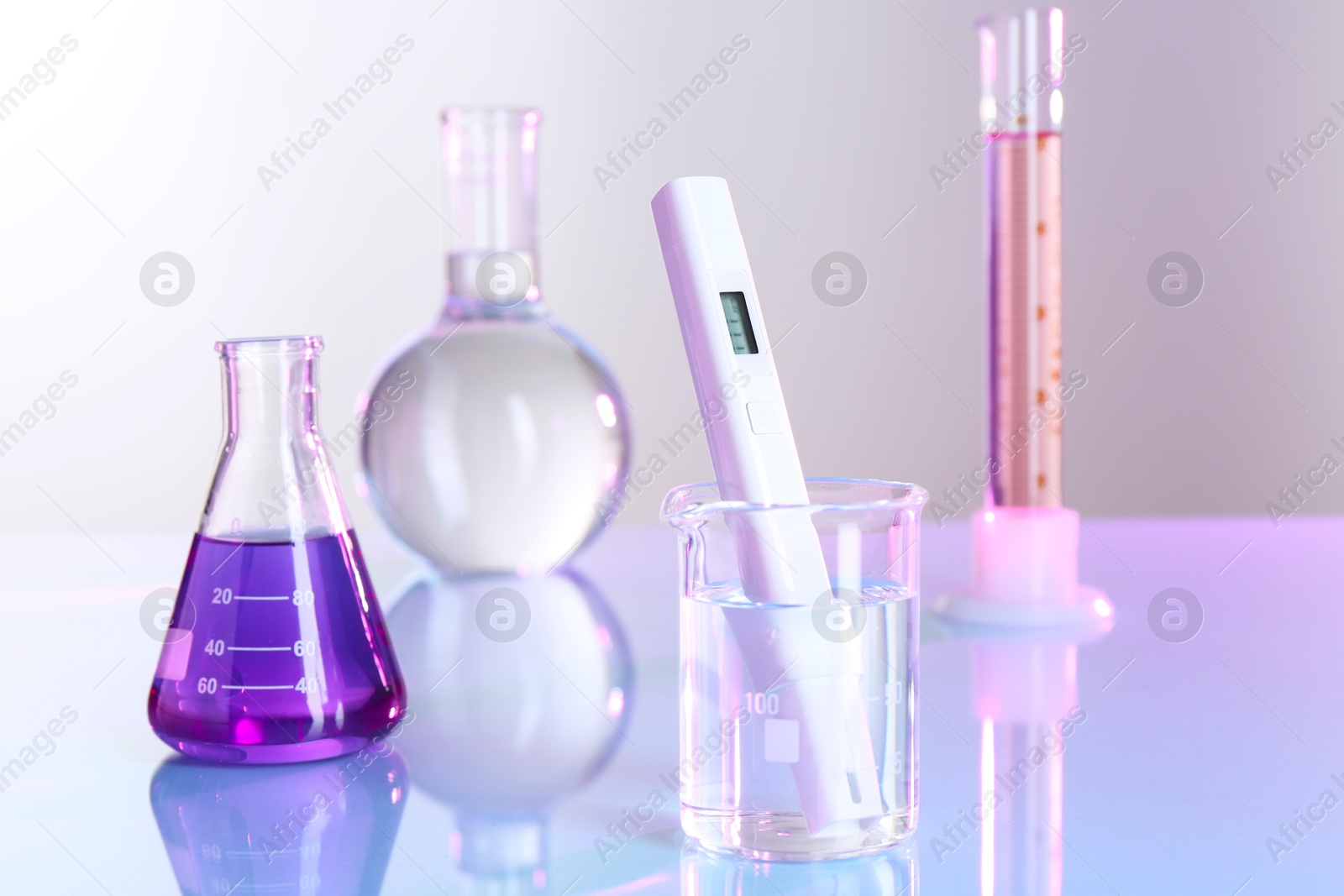 Nitrate tester in beaker with water and glassware on white table, closeup Photo of Nitrate tester in beaker with water and glassware on white table, closeup