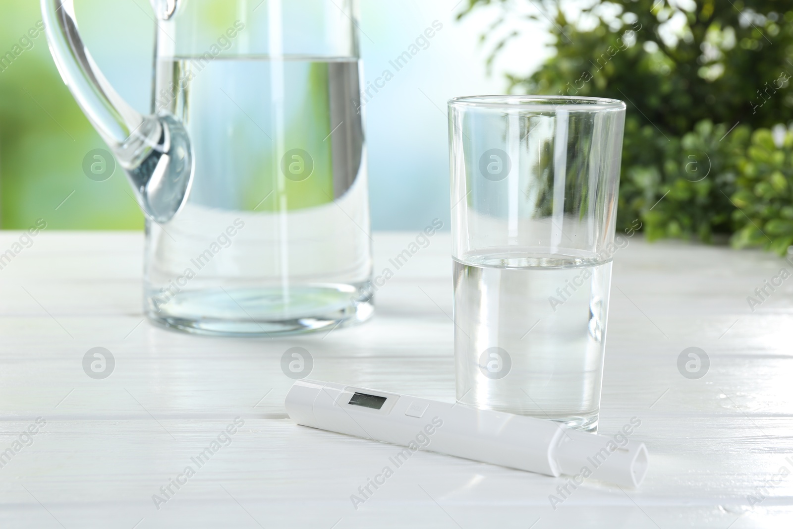 Nitrate tester and glass of water on white wooden table, closeup Photo of Nitrate tester and glass of water on white wooden table, closeup