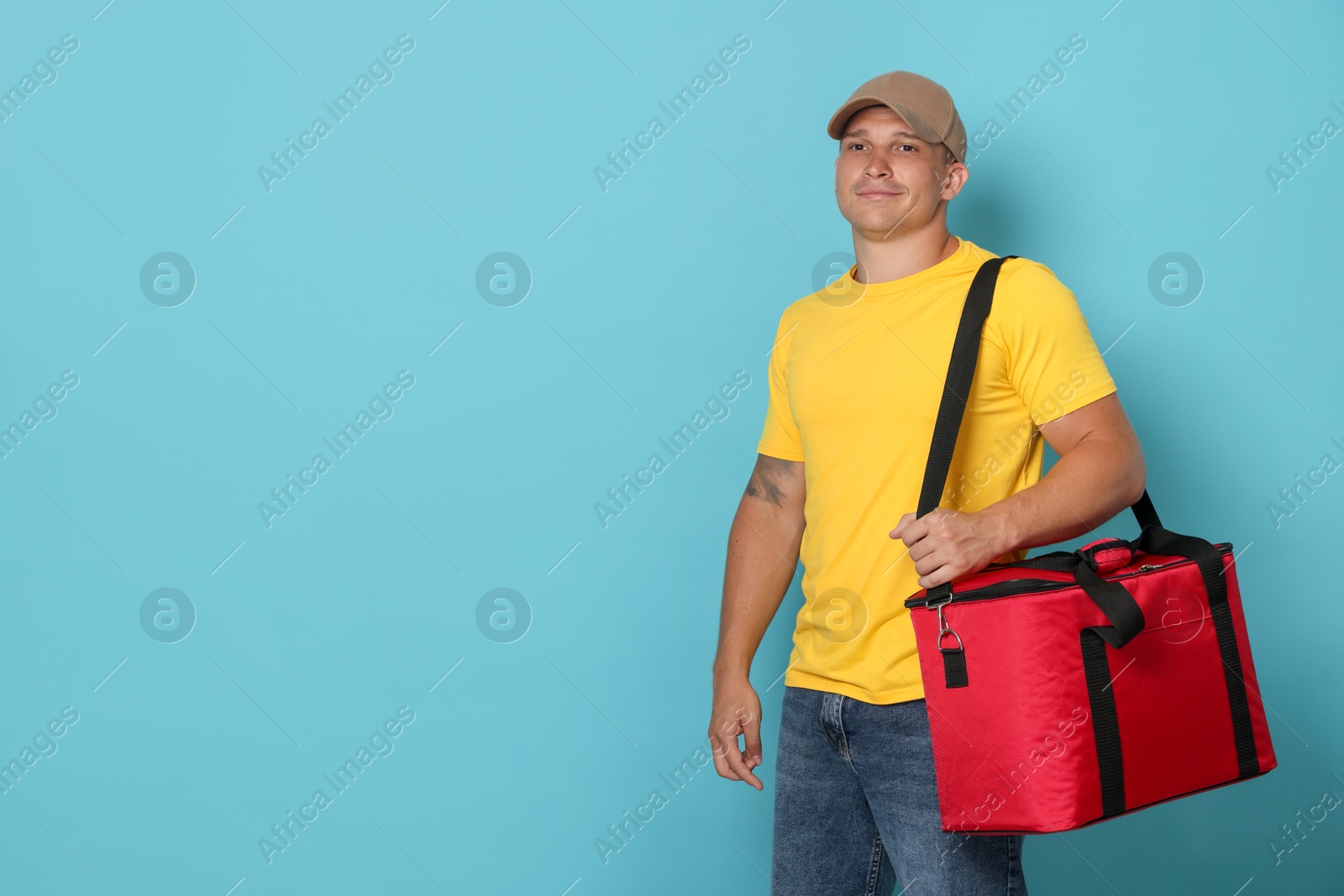 Courier with thermo bag on light blue background, space for text. Food delivery service Photo of Courier with thermo bag on light blue background, space for text. Food delivery service
