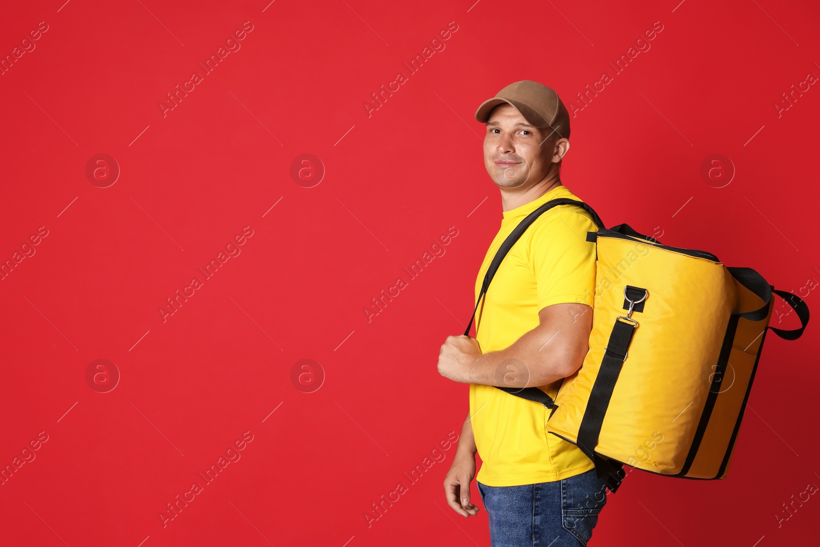 Courier with thermo bag on red background, space for text. Food delivery service Photo of Courier with thermo bag on red background, space for text. Food delivery service
